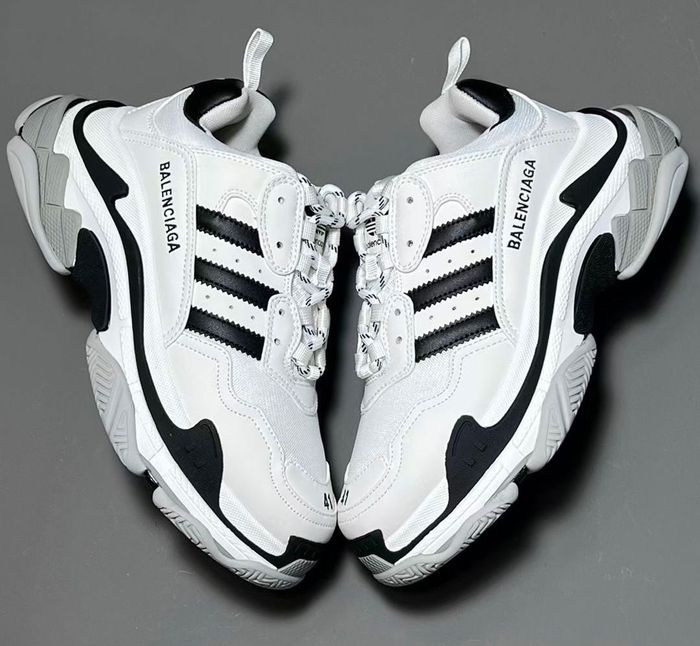 Balenciaga x adidas Triple S product image of a white sneaker with black details.