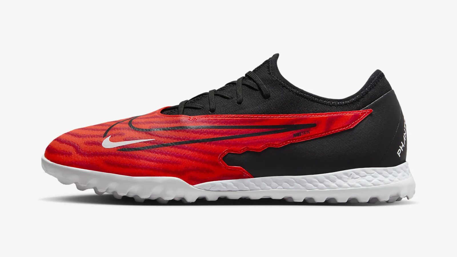 Nike React Phantom GX Pro TF product image of a red and black astro turf boot featuring a white midsole.