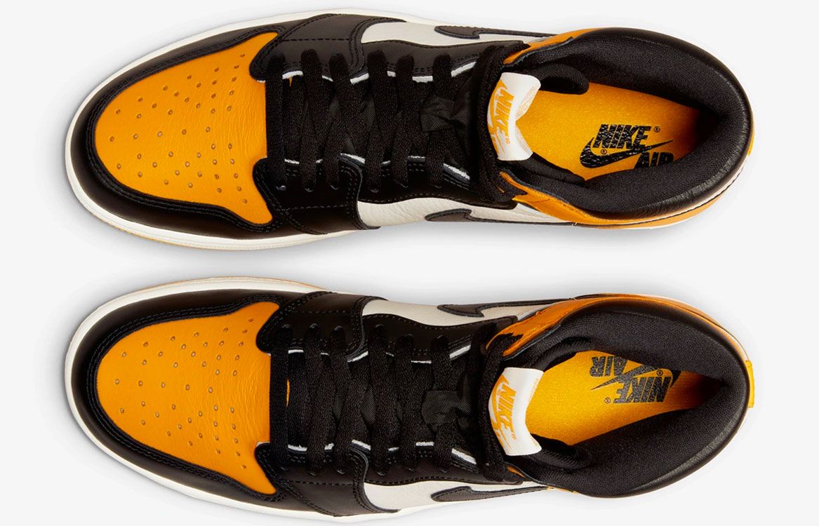 Air Jordan 1 High OG "Taxi" product image of a white and black sneaker with yellow overlays. 