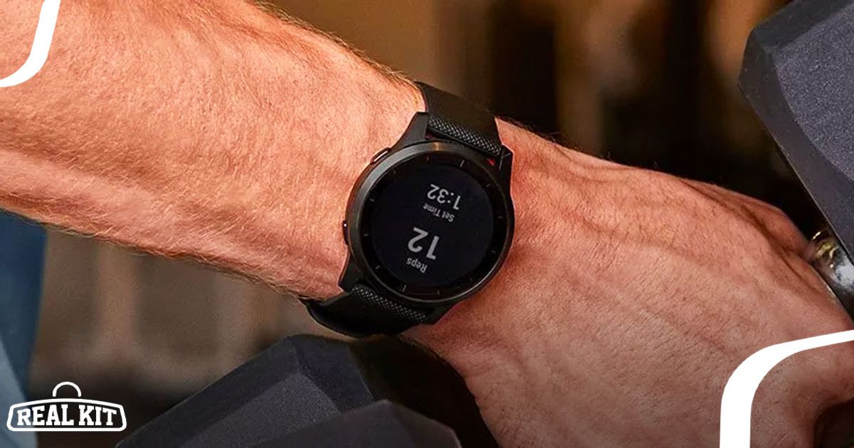 Image of a black Garmin smartwatch on the wrist of someone picking up a dumbbell.