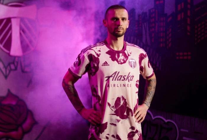 Best football kits 2022/23 Portland Timbers away kit product image of a light pink shirt with a dark rose pattern.