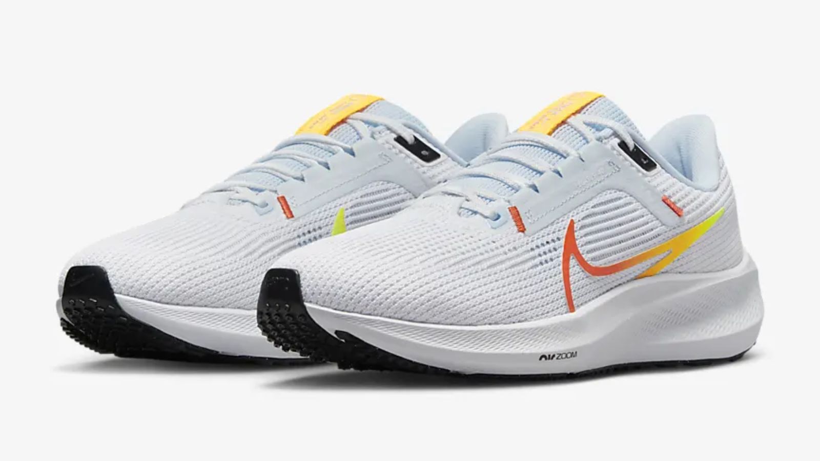 Nike Pegasus 40 product image of white running shoes featuring yellow and orange Swooshes.