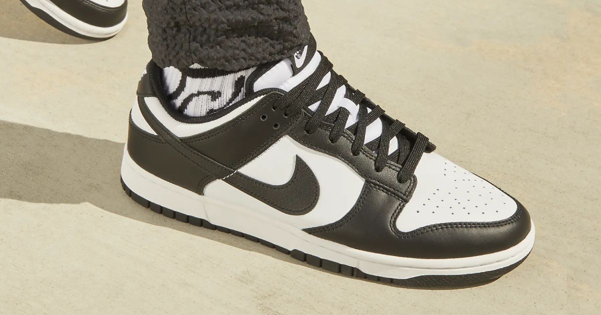 Someone in a pair of black and white Nike Dunk Lows
