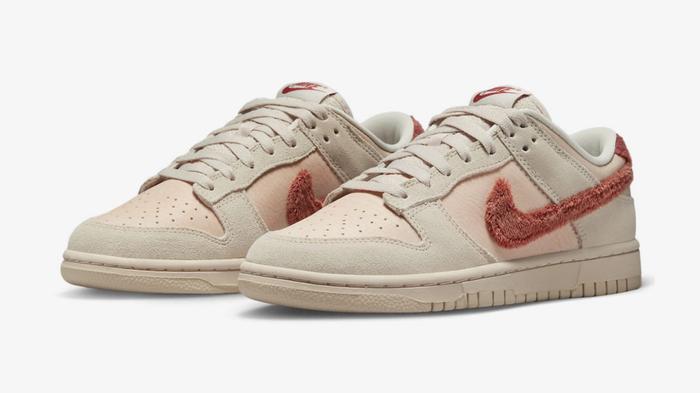 How to lace Dunks - "Terry Swoosh" Low product image of a pair of light cream and brown sneakers with burnt orange soft Swooshes.
