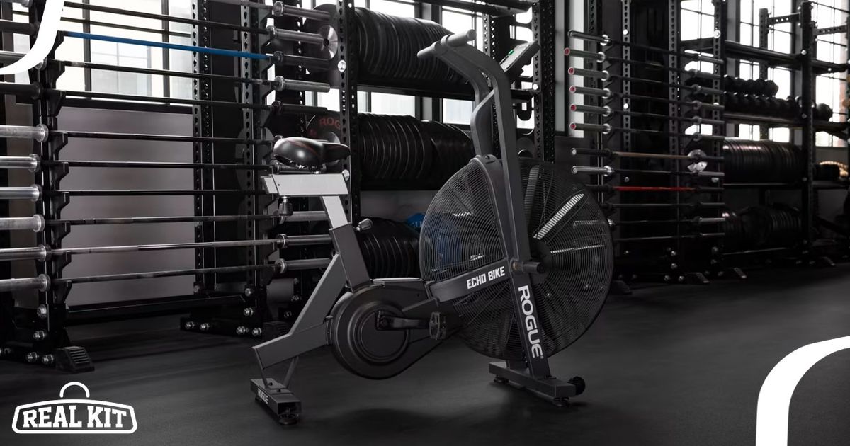 Image of a black Rogue air bike featuring white branding in a gym.