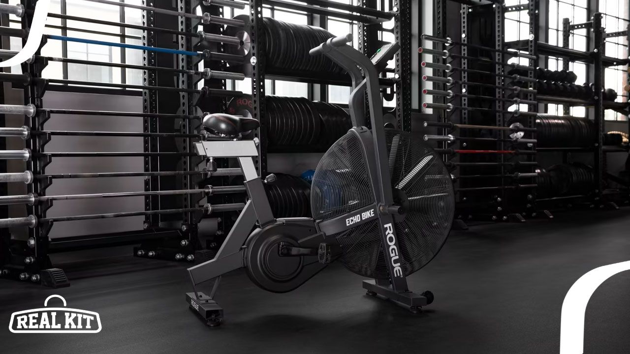 Image of a black Rogue air bike featuring white branding in a gym.