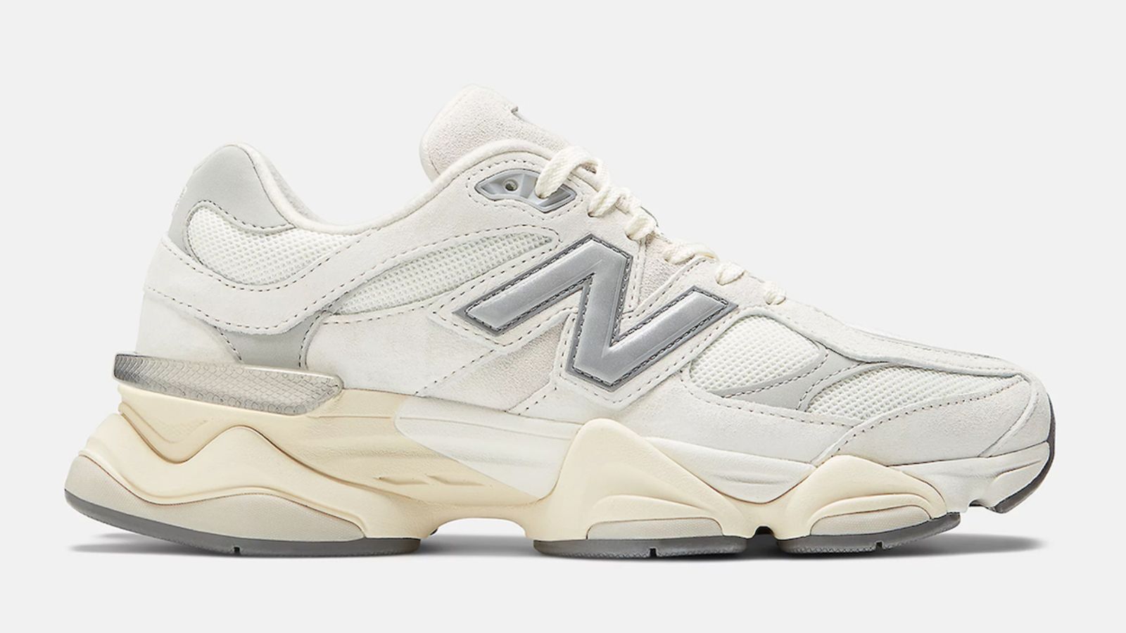 New Balance 9060 "Sea Salt" product image of a white New Balance trainer with a pre-aged midsole and silvery grey accents.
