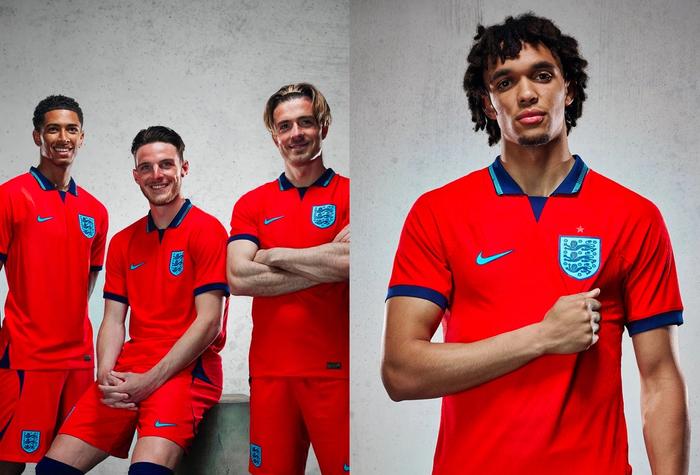 Best football kits 2022/23 Nike away kit product image of red shirt with a navy collar and accents.