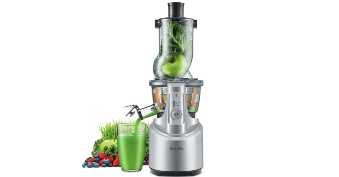 Best juicer Breville product image of a silver machine mid-way through creating a green juice.