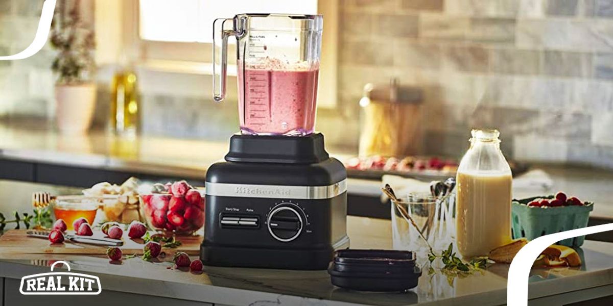 Image of a black blender on a kitchen surface with a pink drink in the clear jug.