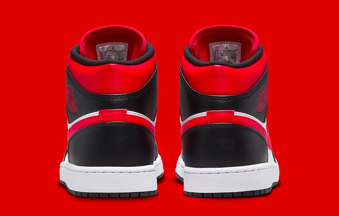 Air Jordan 1 Mid "Bred Toe" product image of a white and red sneaker with black overlays.