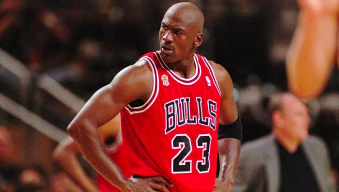 Best NBA jerseys of all time Chicago Bulls product image of Michael Jordan wearing a red kit with black numbers and lettering outlined in white.