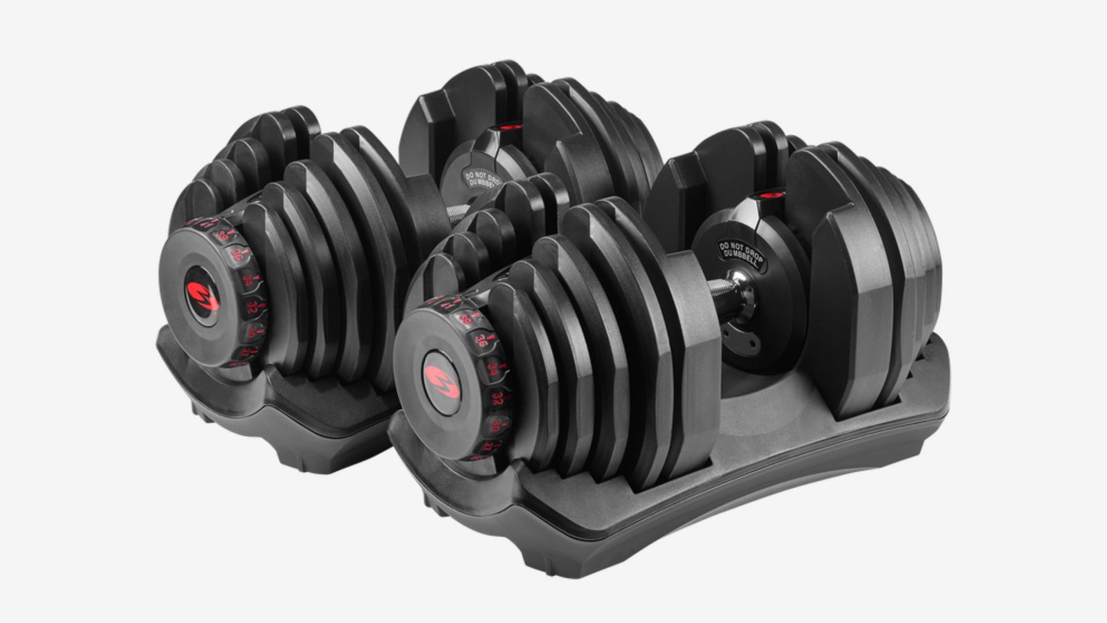 Bowflex SelectTech 1090i product image of a pair of black adjustable dumbbells in stands with red dials on the end.