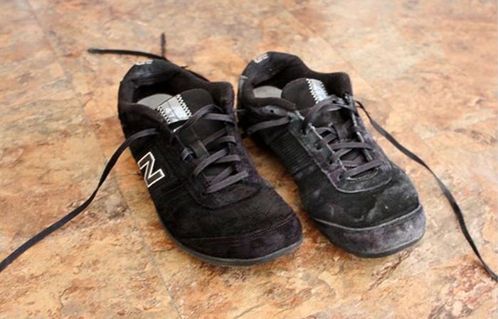 Image of a black suede New Balance shoes with salt stains.