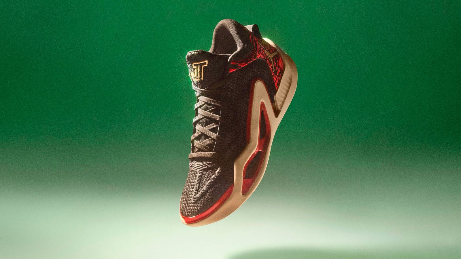 Jayson Tatum's Jordan Tatum 1 "Zoo" product image of a black sneaker with a red animal print pattern around the heel.