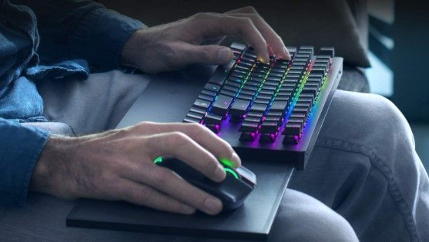 Black mouse and keyboard with rainbow, backlit keys.