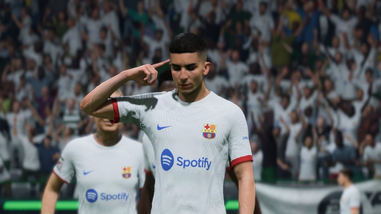 Ferran Torres in EA FC 24 wearing a white Barcelona kit featuring red trim and blue branding while doing the Rashford celebration.