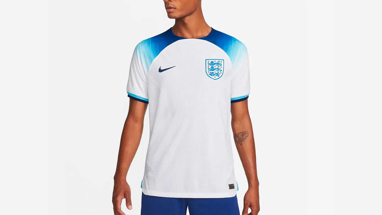 England 2022 World Cup home kit Nike product image of a white shirt with navy blue gradient accents across the shoulders.