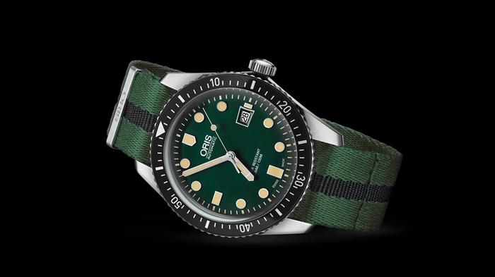 Best watches under 1500 Oris product image of a silver watch with a black bezel and a green and black band.