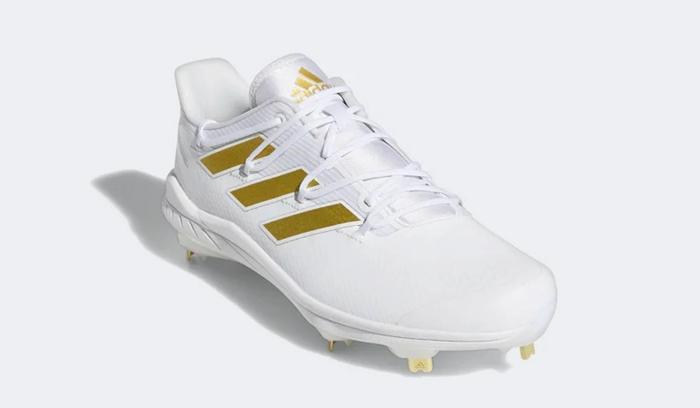 Best baseball cleats adidas product image of a white and gold cleat.