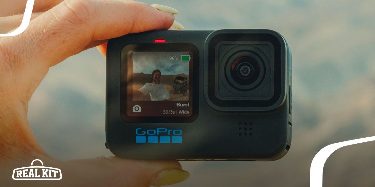 Image of a black GoPro in-hand facing the person.