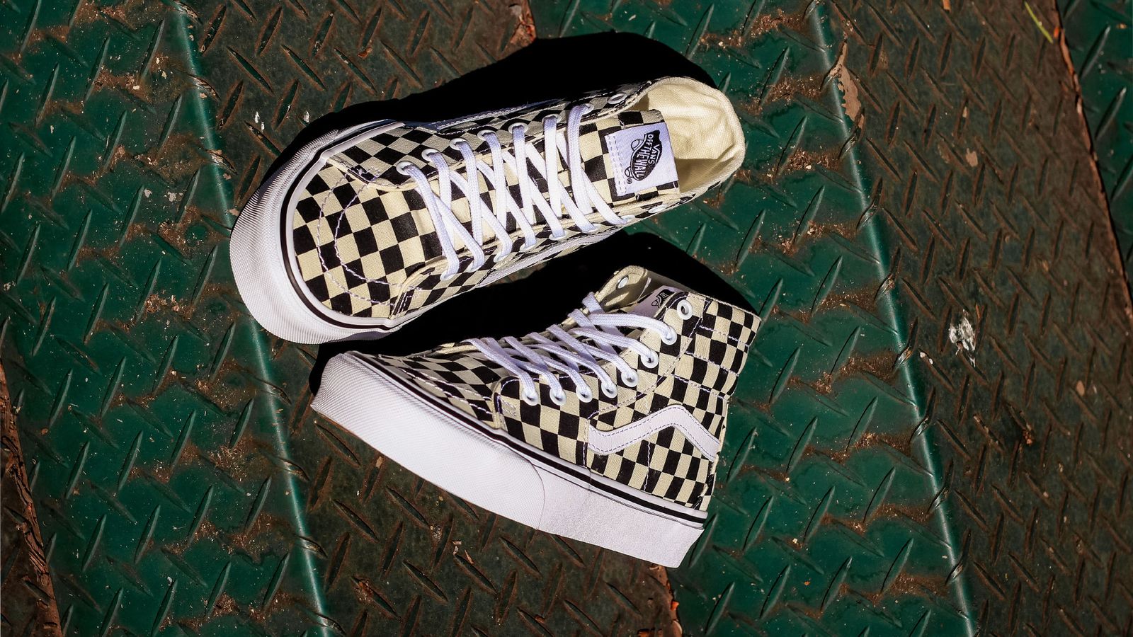 Vans Sk8-Hi image of a pair of white and black checkerboard sneakers.
