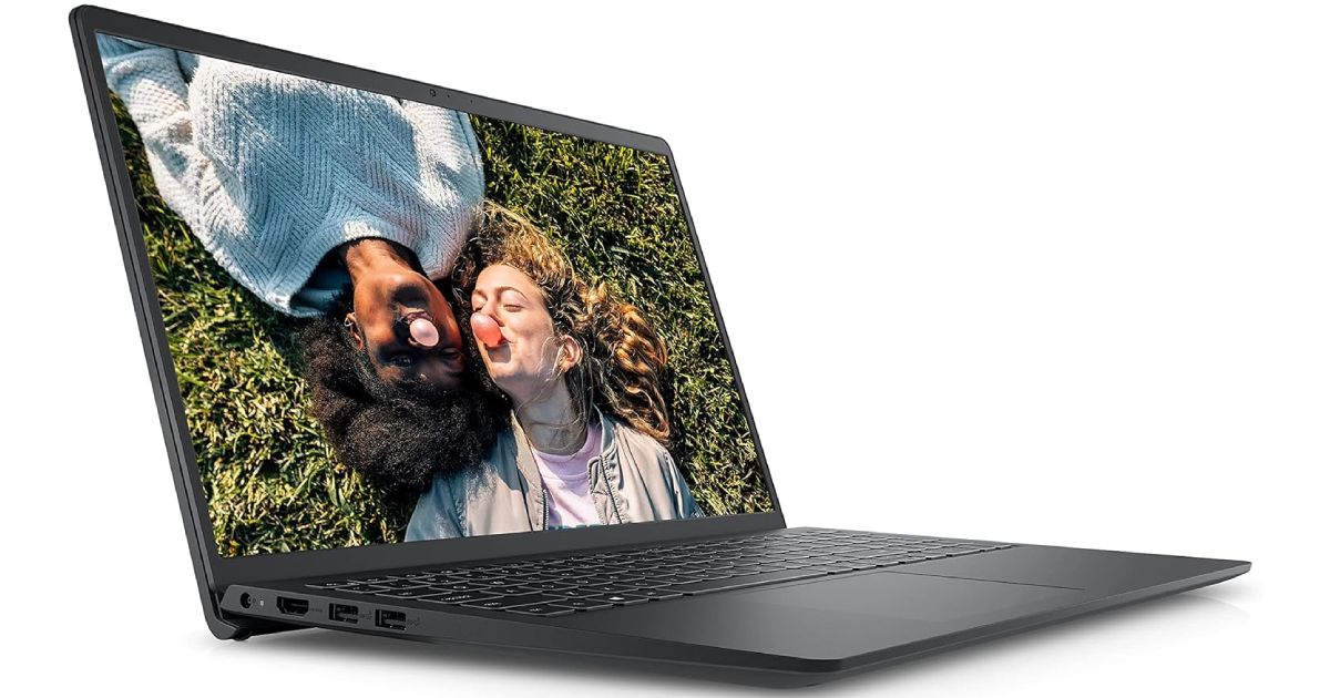 Dell Inspiron 15 3000 product image of a black laptop with an image of two people laying on grass on the display.