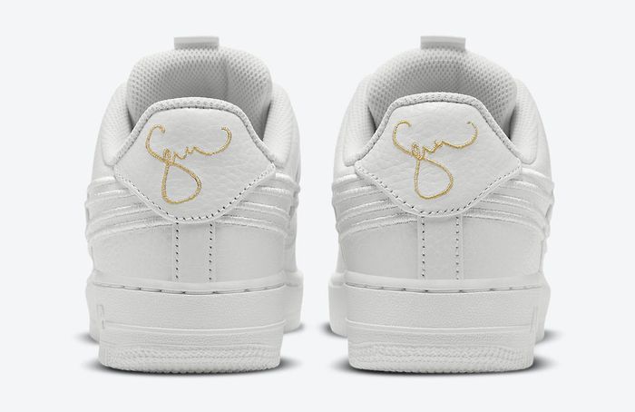 Serena Williams Design Crew x Nike Air Force 1 Summit White product image of an all-white sneaker with golden accepts including a zip-up lock-in system.