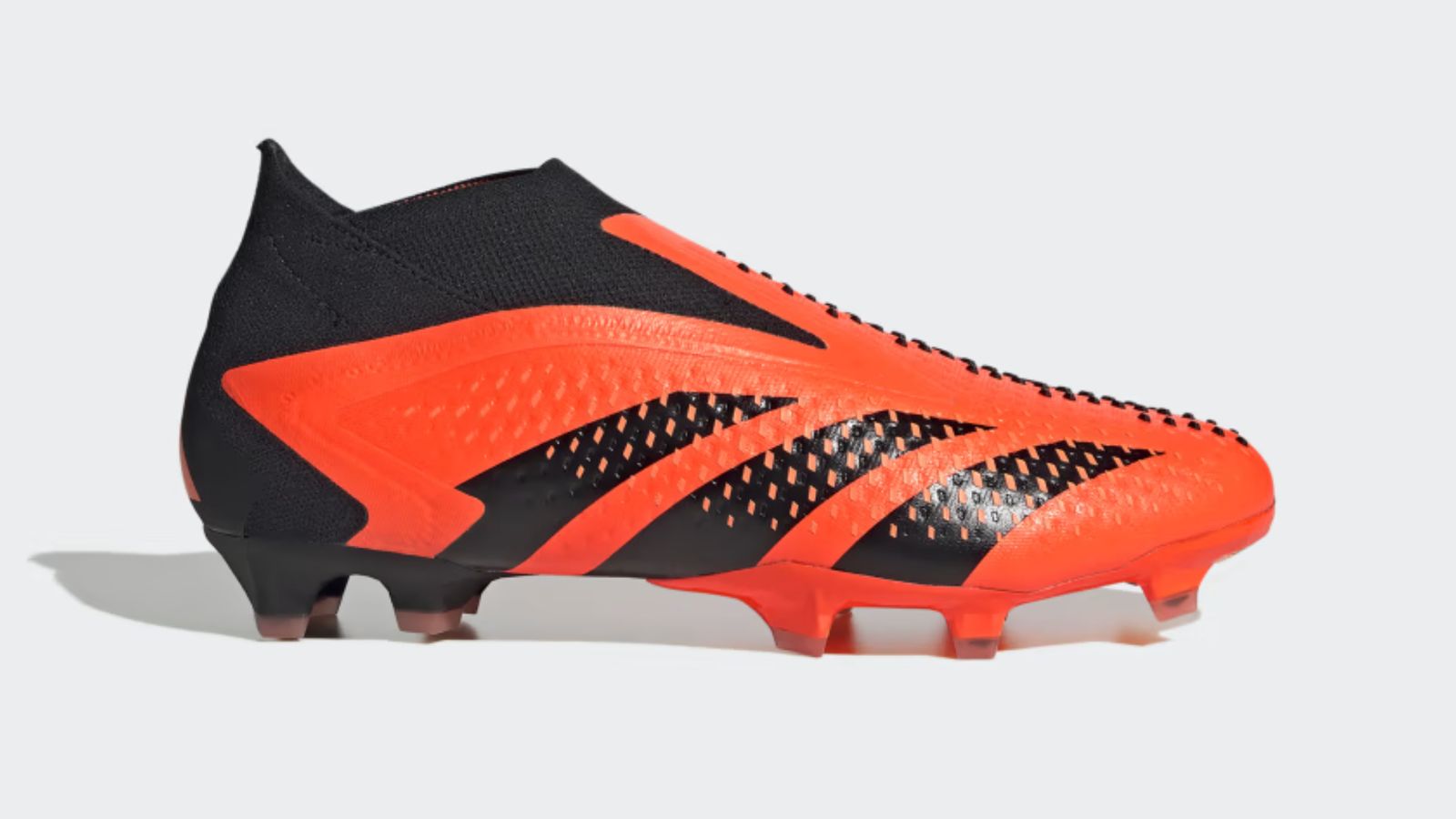 adidas Predator Accuracy+ product image of an orange and black laceless football boot, with added "studs" across the upper.