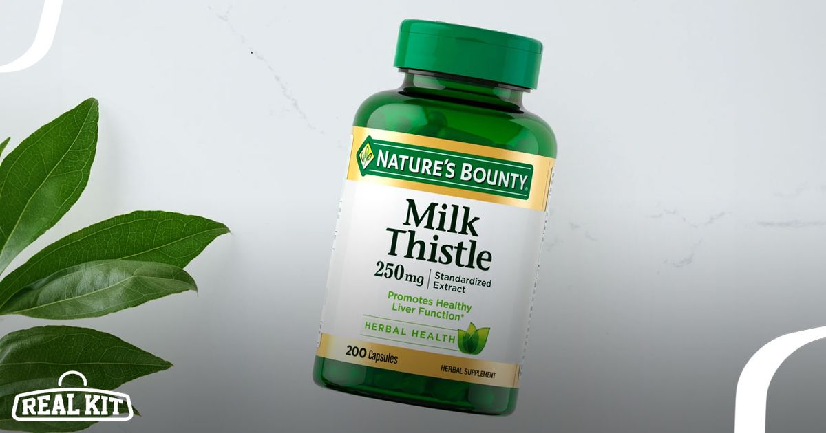 A  green vitamin container with gold and white branding on the label next to a green leaf.