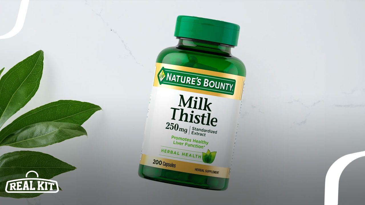A  green vitamin container with gold and white branding on the label next to a green leaf.