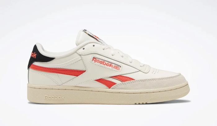 Best sneakers for fall Reebok Club C Revenge product image of a white leather and suede sneaker with light orange accents.