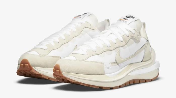 best sneakers for summer sacai x Nike VaporWaffle "Sail" product image of white and Sail sneakers next to an orange Nike shoe box.