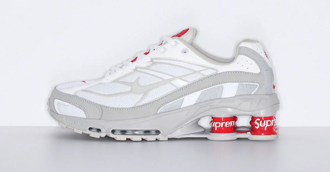 Supreme x Nike Shox Ride 2 product image of a white pair of sneakers with Supreme-branded cushioning columns in the heels.