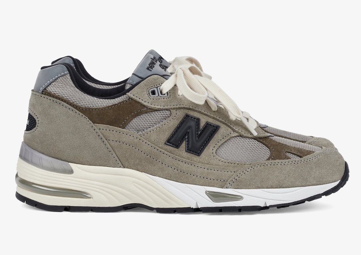 JJJJound x New Balance 991 "Grey Olive" shoes sporting earth tones with black and silver details constructed in a mix of mesh, suede, and leather materials