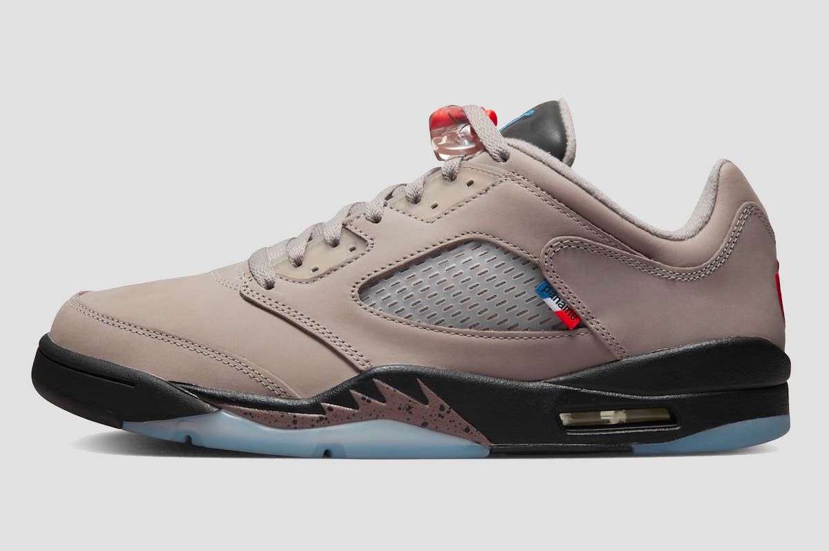 PSG x Air Jordan 5 Low product image of grey sneakers with red lace toggles and French motifs.