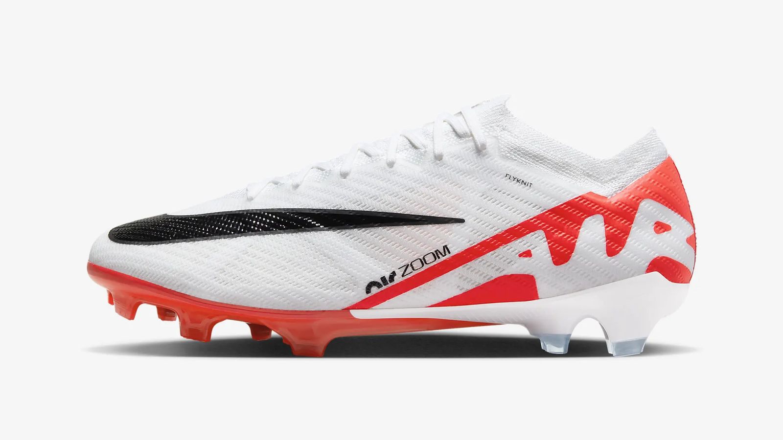 Nike Zoom Mercurial Vapor 15 Elite product image of a white boot with "Air" branding outlined in orange at the heel and an oversized black Swoosh at the front.