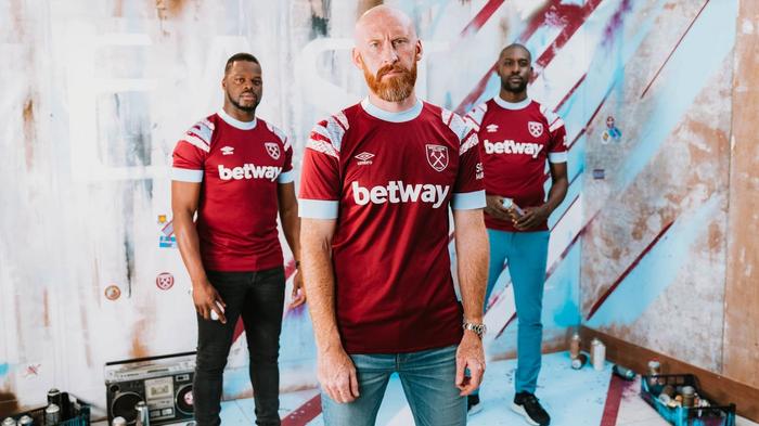 West Ham Umbro home kit product image of a claret red shirt with light blue and white accents.