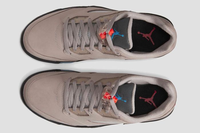 PSG x Air Jordan 5 Low product image of grey sneakers with red lace toggles and French motifs.