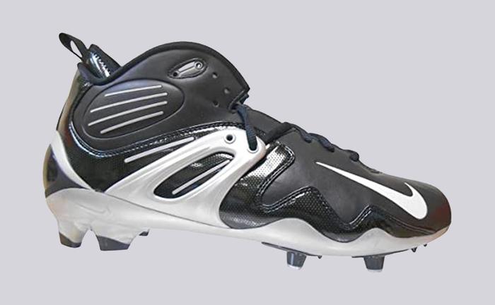 Nike product image of a black leather cleat with synthetic white details.
