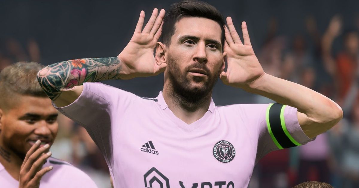 Lionel Messi in a pink Inter Miami shirt with black trim celebrating with his hands against his ears.