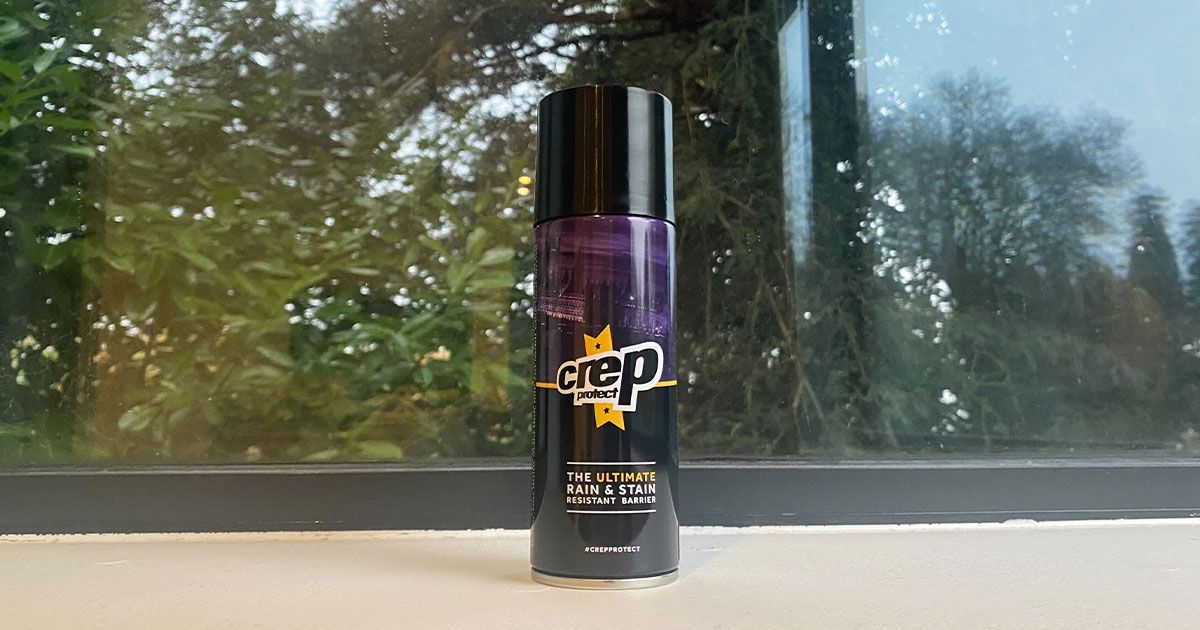 A black and purple spray can with white and yellow branding on the front.