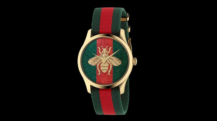 Best watches under 1500 Gucci product image of a golden watch with a red and green band, with a golden bee in the centre.