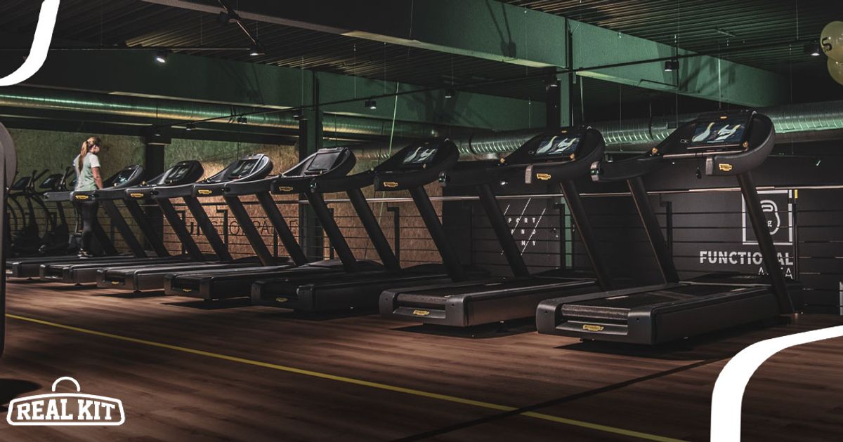 Image of a line of black treadmills in a gym.