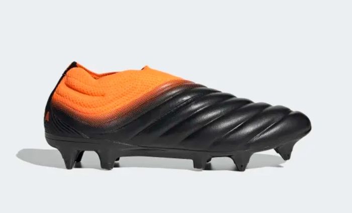 Best football boots adidas Copa20+ product image of two black boots with orange details.