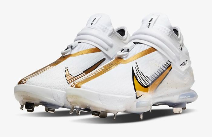 Best baseball cleats Nike product image of a pair of white and gold cleats.