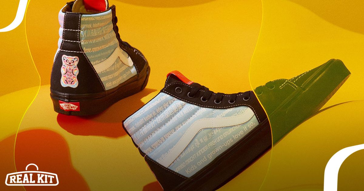 Image of two black and blue Vans Sk8-Hi sneakers on a yellow surface.