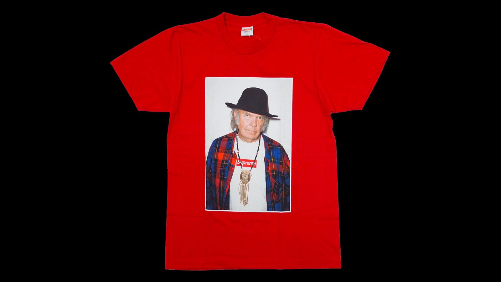 Supreme Neil Young Tee product image of a red t-shirt with Neil Young pictured in the centre wearing a white box logo tee and a black hat.