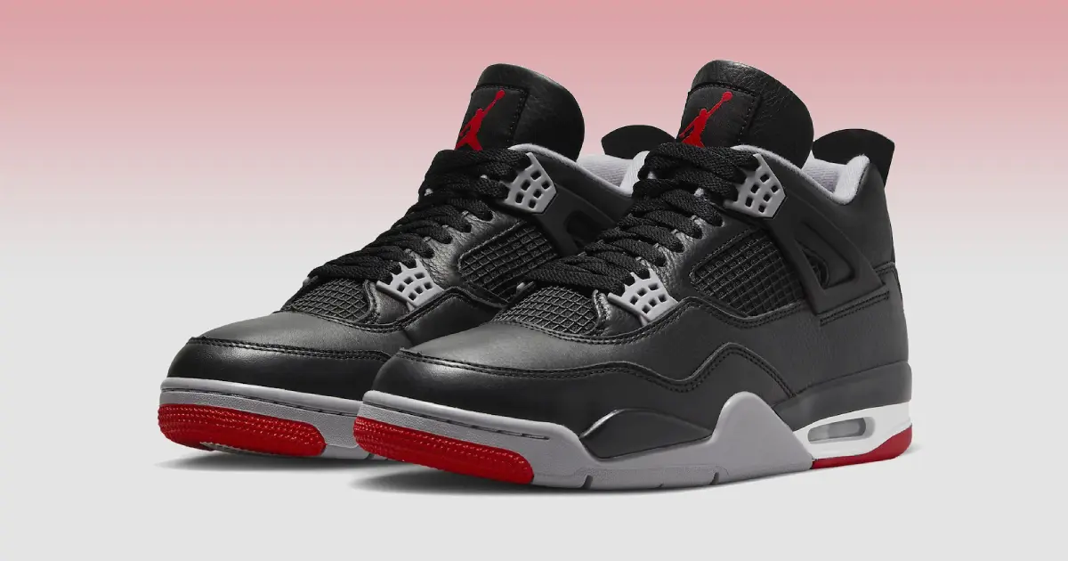 A pair of black Jordan 4s with grey, white, and red design details.