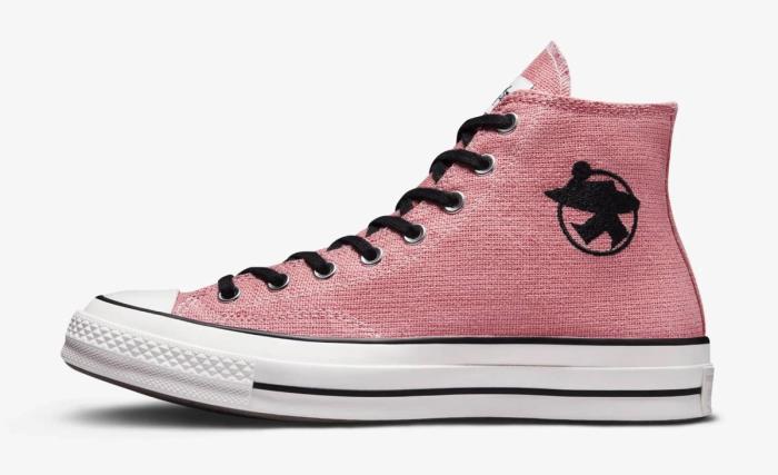Stüssy x Converse "Surfman Pink" All Stars product image of a pink canvas sneaker with black details and a white midsole.